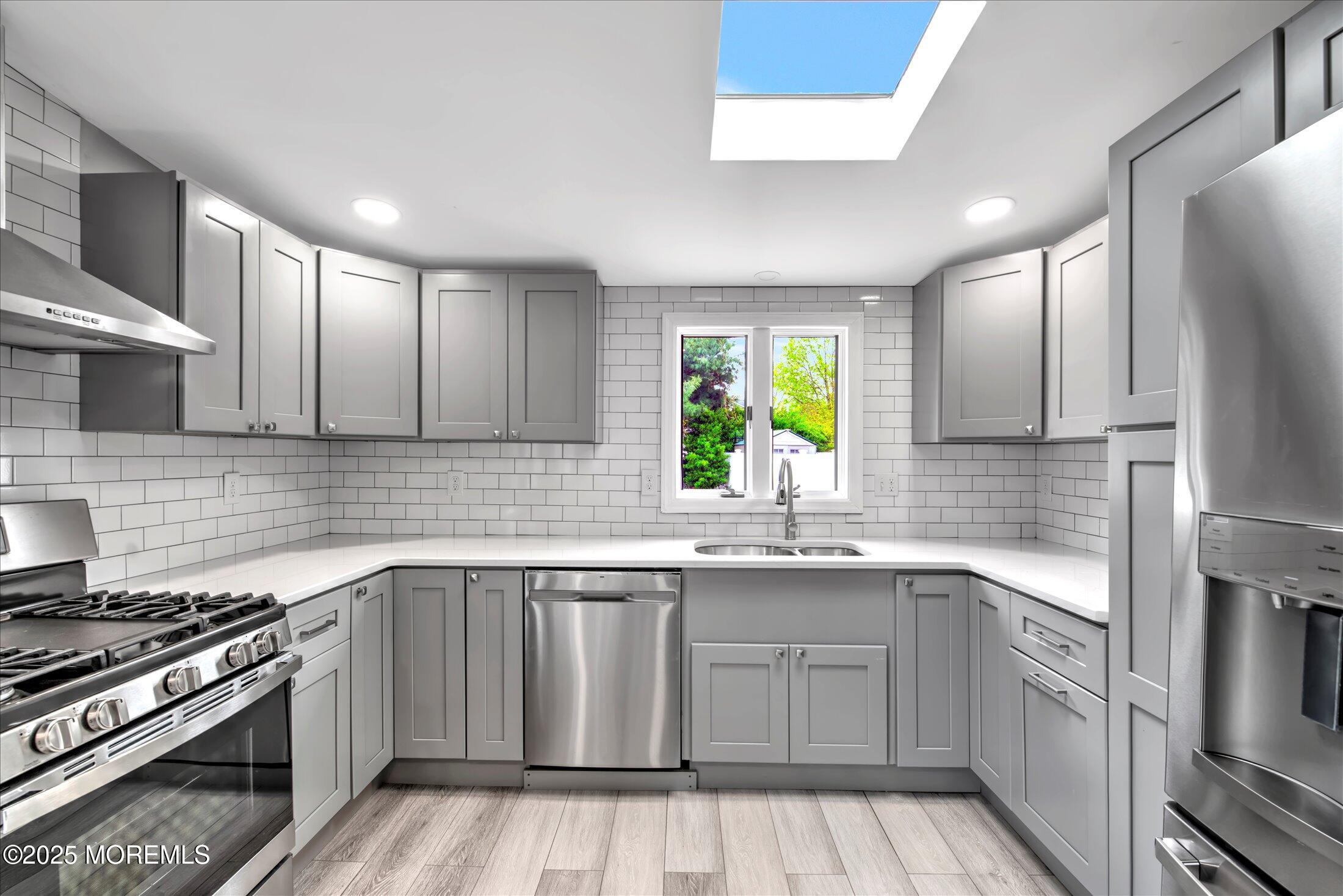 314 Motor Road Pine Beach, NJ 08741 - Photo 17 of 38 a kitchen with a sink stove and cabinets