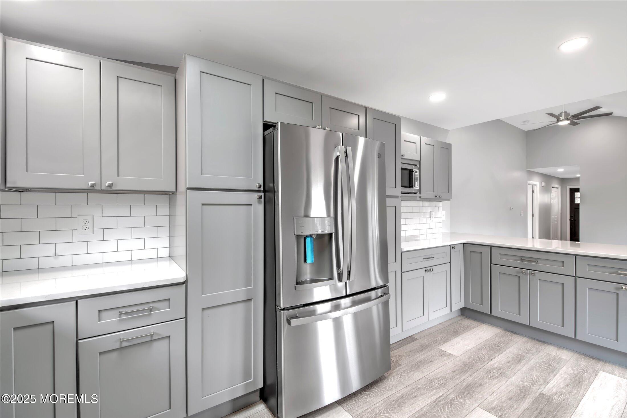 314 Motor Road Pine Beach, NJ 08741 - Photo 18 of 38 a kitchen with stainless steel appliances white cabinets and a refrigerator