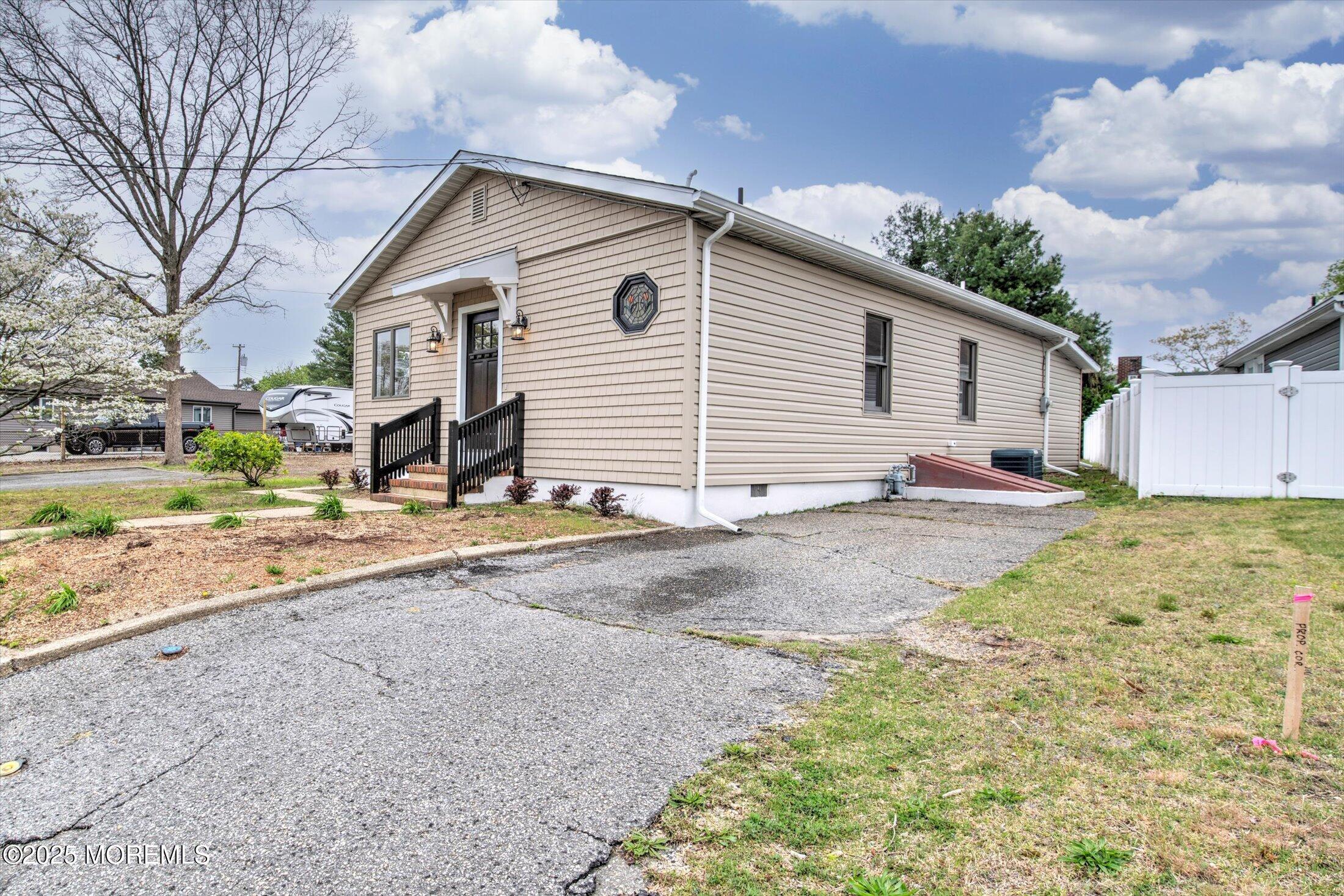 314 Motor Road Pine Beach, NJ 08741 - Photo 2 of 38 a view of a white house with a yard and large tree