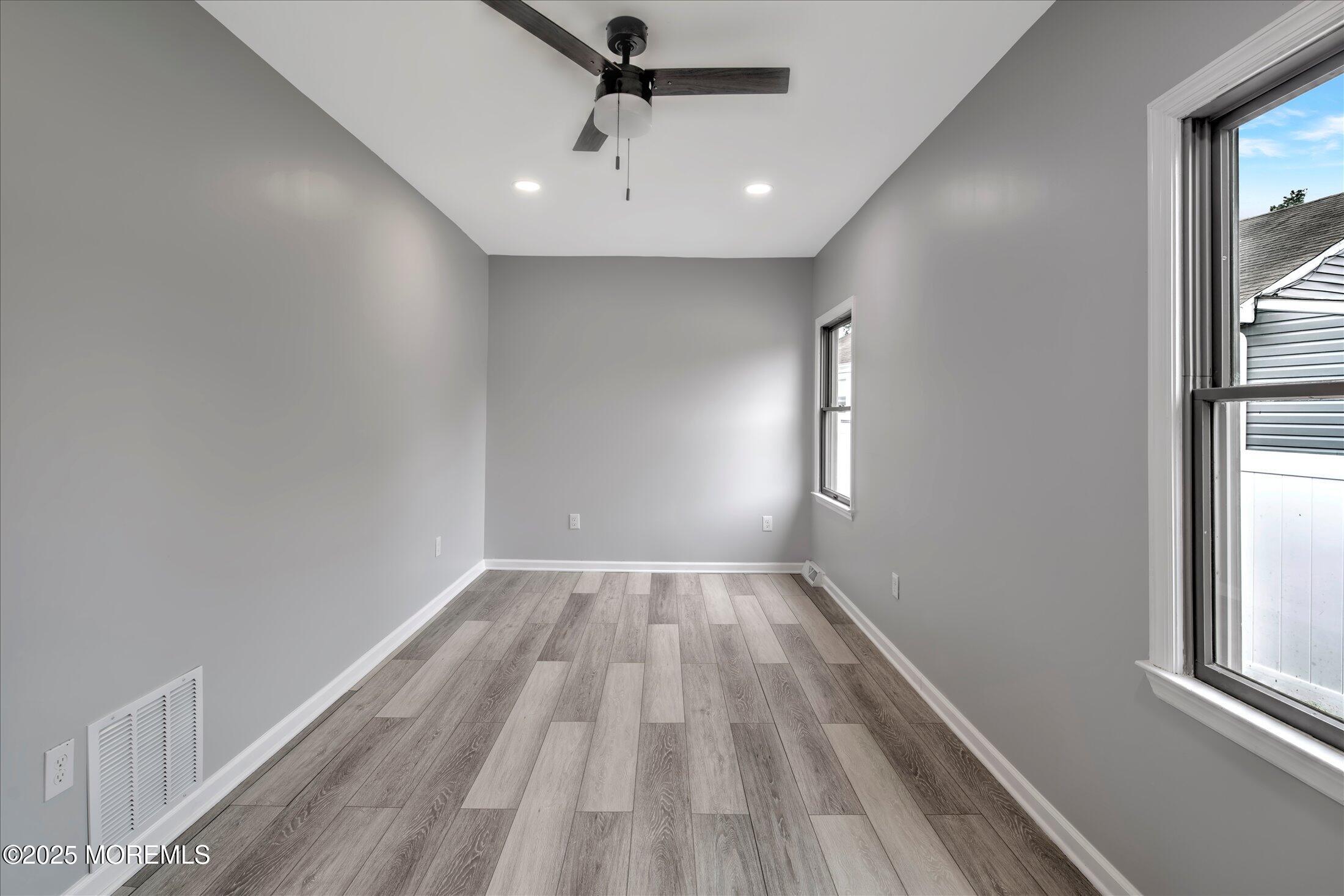 314 Motor Road Pine Beach, NJ 08741 - Photo 21 of 38 a view of empty room with wooden floor and fan