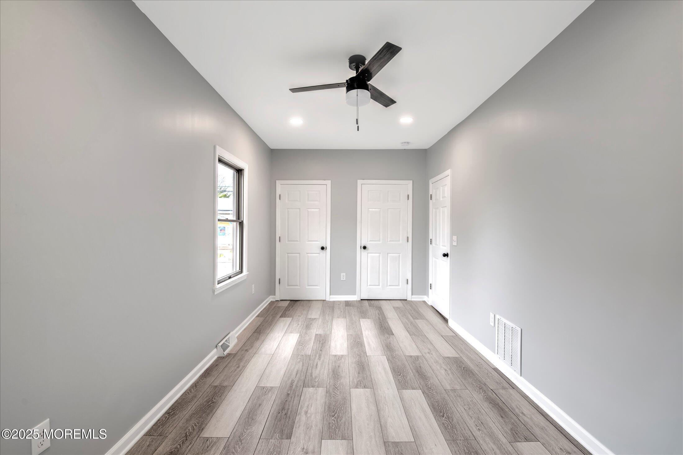 314 Motor Road Pine Beach, NJ 08741 - Photo 22 of 38 a view of empty room with wooden floor and fan