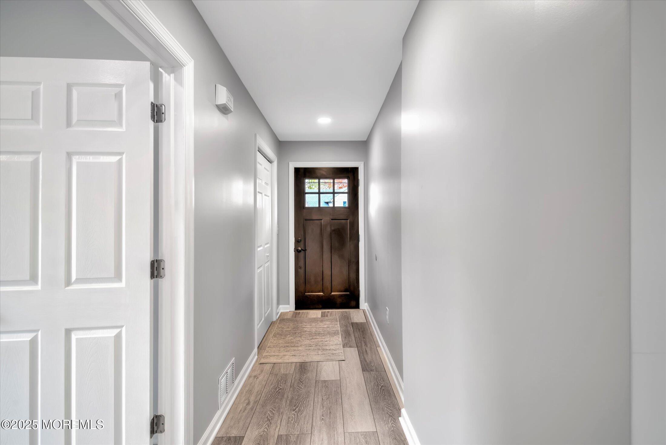 314 Motor Road Pine Beach, NJ 08741 - Photo 3 of 38 a view of a hallway with wooden floor
