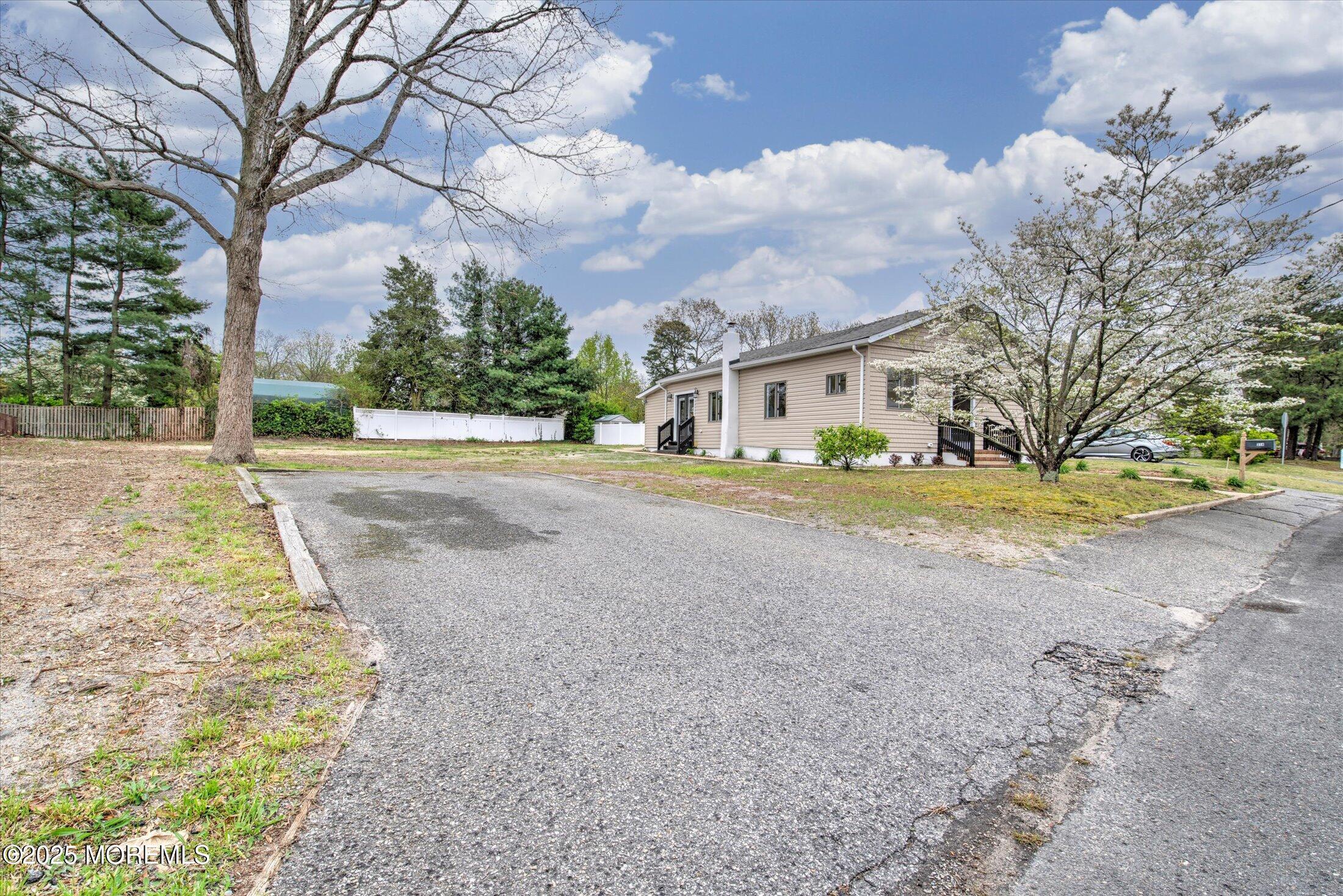 314 Motor Road Pine Beach, NJ 08741 - Photo 38 of 38 a front view of a house with a yard and trees