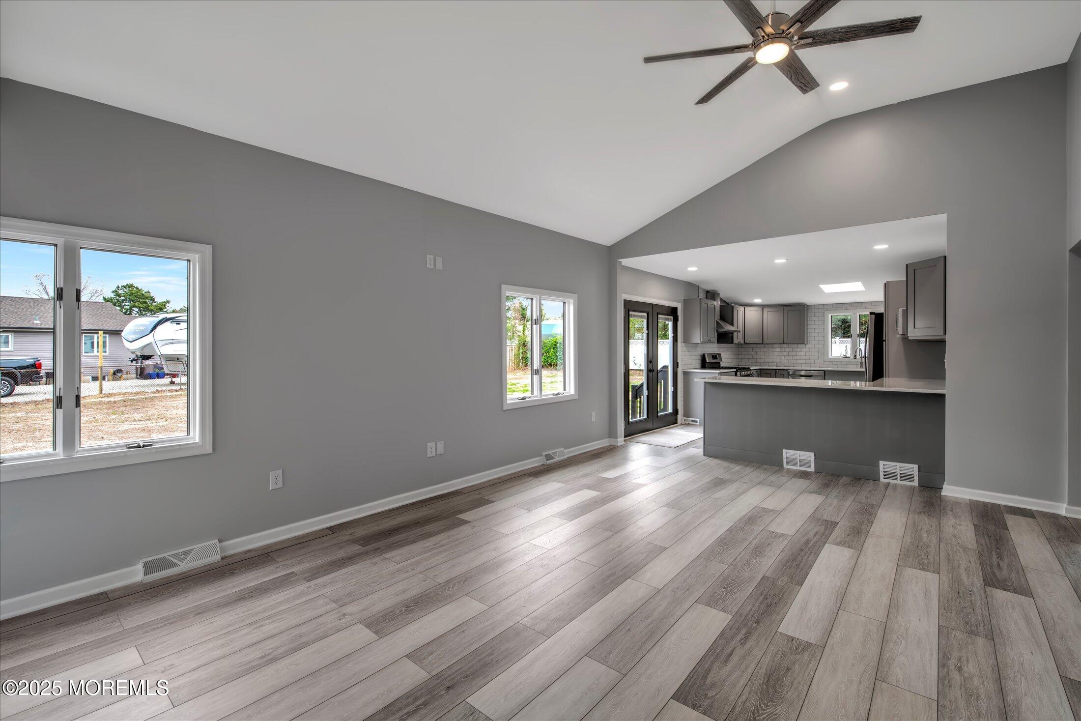 314 Motor Road Pine Beach, NJ 08741 - Photo 4 of 38 a view of an empty room with window and wooden floor