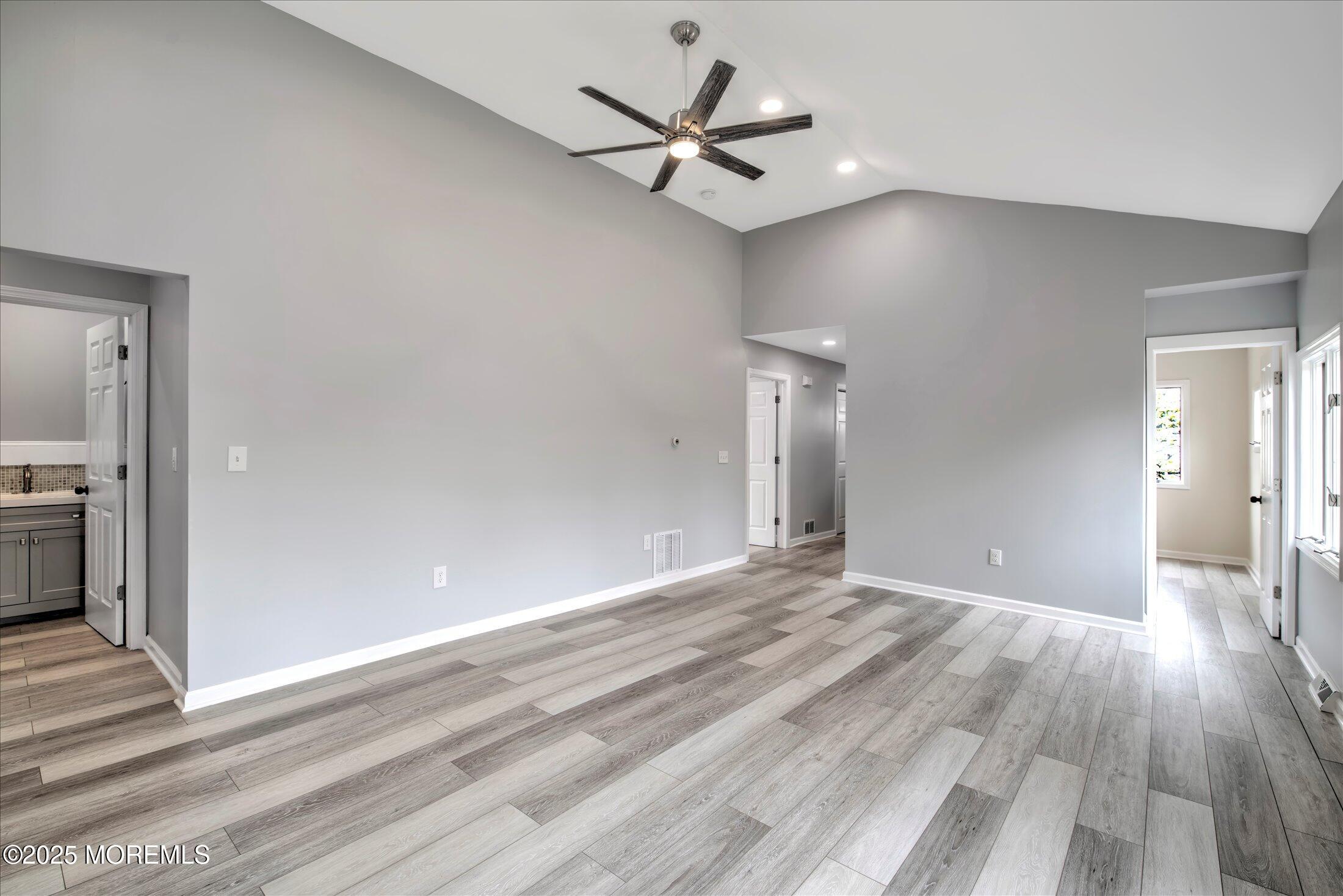 314 Motor Road Pine Beach, NJ 08741 - Photo 7 of 38 wooden floor in an empty room with a ceiling fan