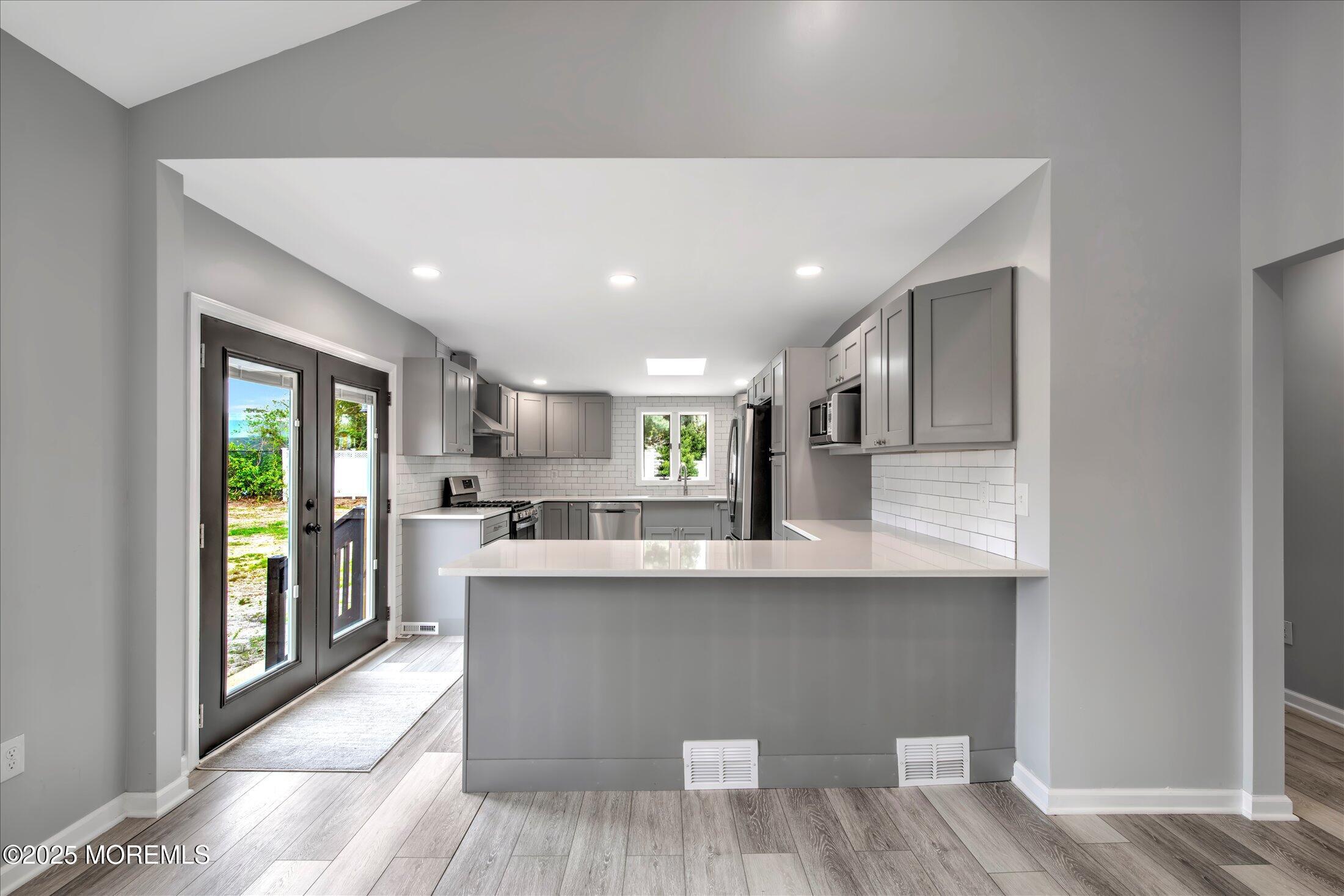 314 Motor Road Pine Beach, NJ 08741 - Photo 10 of 38 a large kitchen with stainless steel appliances granite countertop a lot of counter space and wooden floors