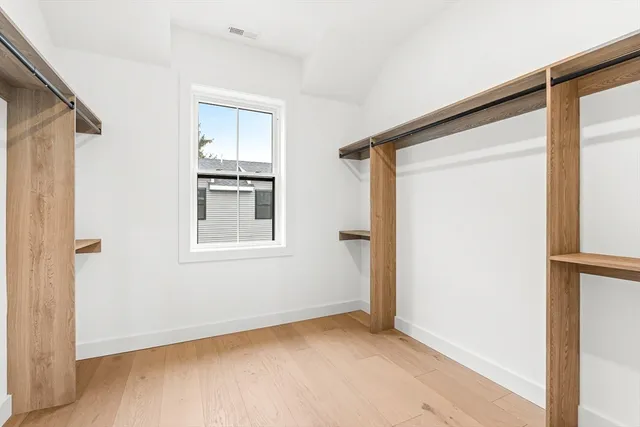 a bathroom with a tub shower sink and mirror