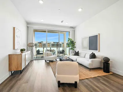 a living room with furniture or couch and a large window