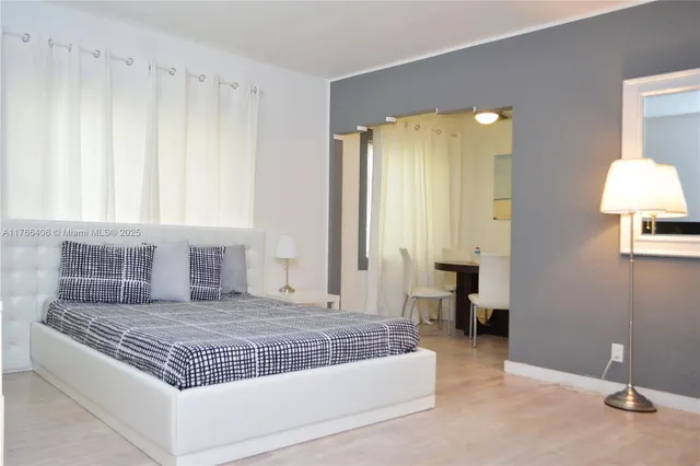 a living room with a bed and a table in it