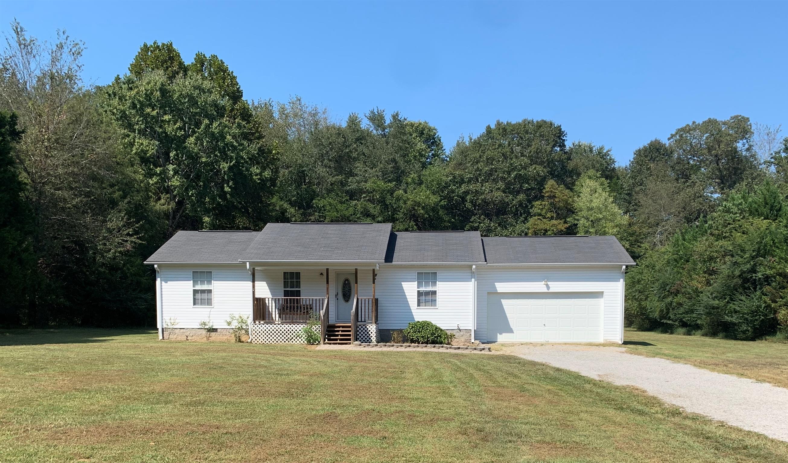 1225 Nelson Road Dickson, TN 37055 - Photo 1 of 18 a front view of a house with a yard and trees