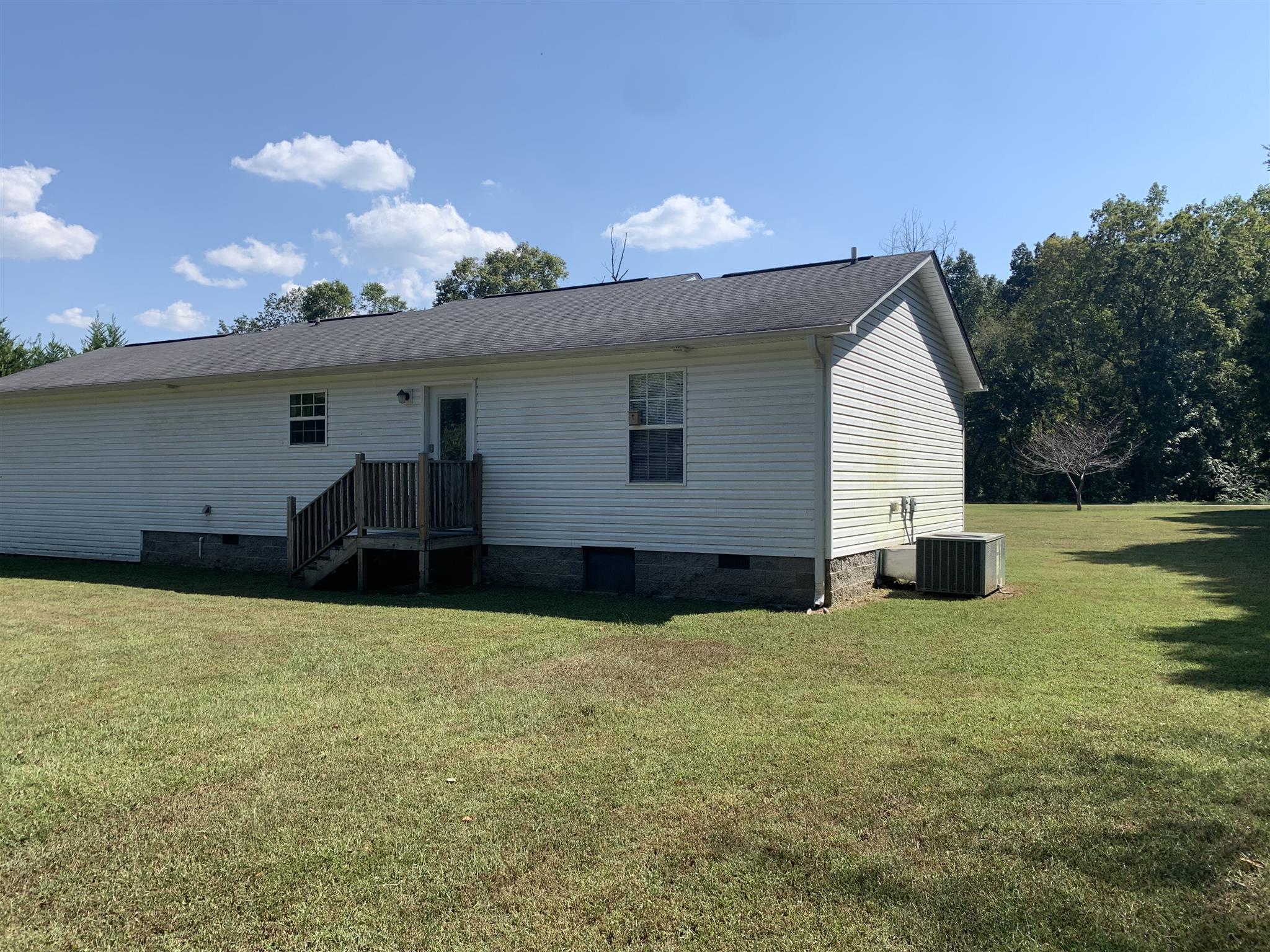 1225 Nelson Road Dickson, TN 37055 - Photo 16 of 18 a view of a house with backyard and basketball court