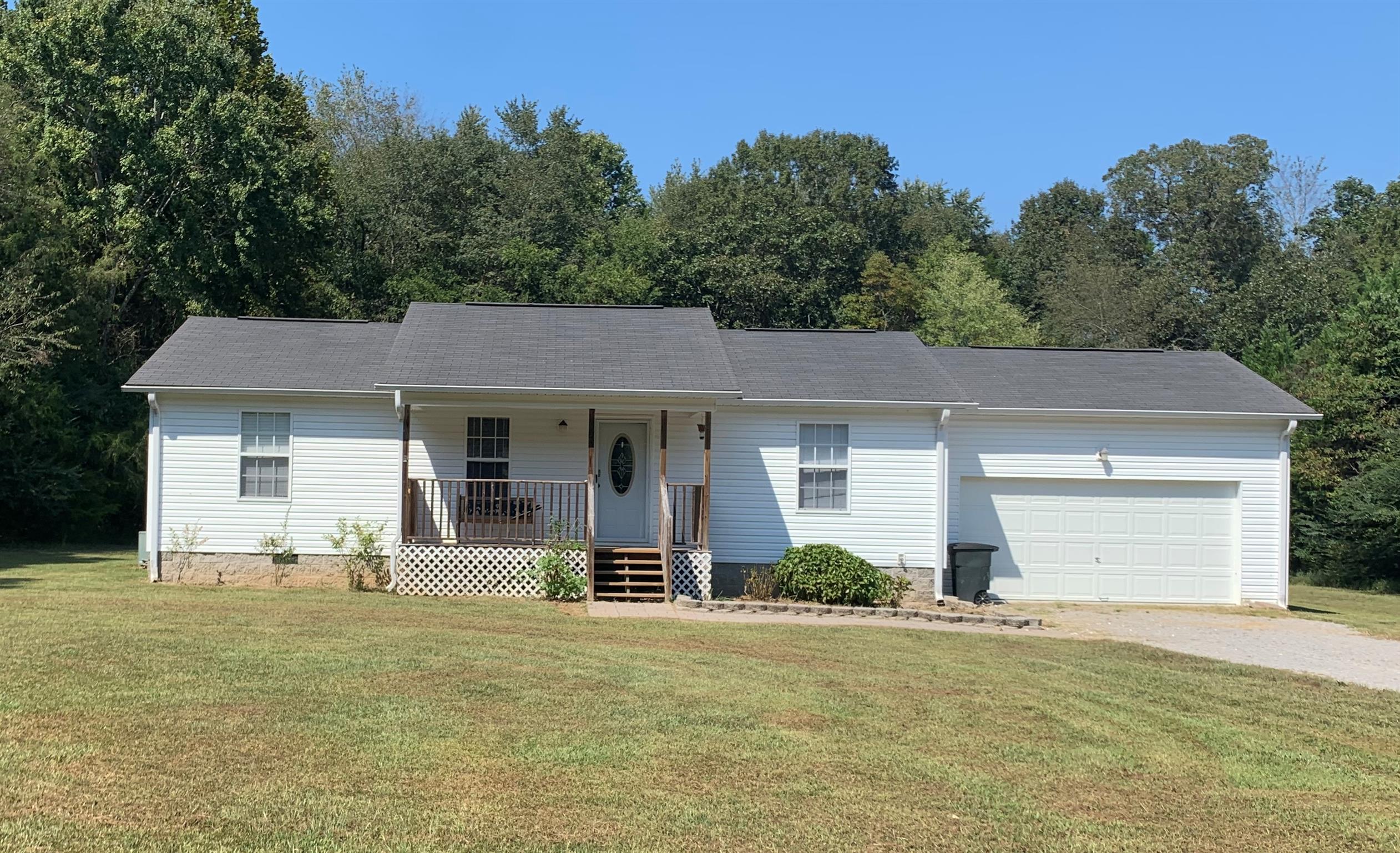 1225 Nelson Road Dickson, TN 37055 - Photo 17 of 18 a front view of a house with a yard and garage