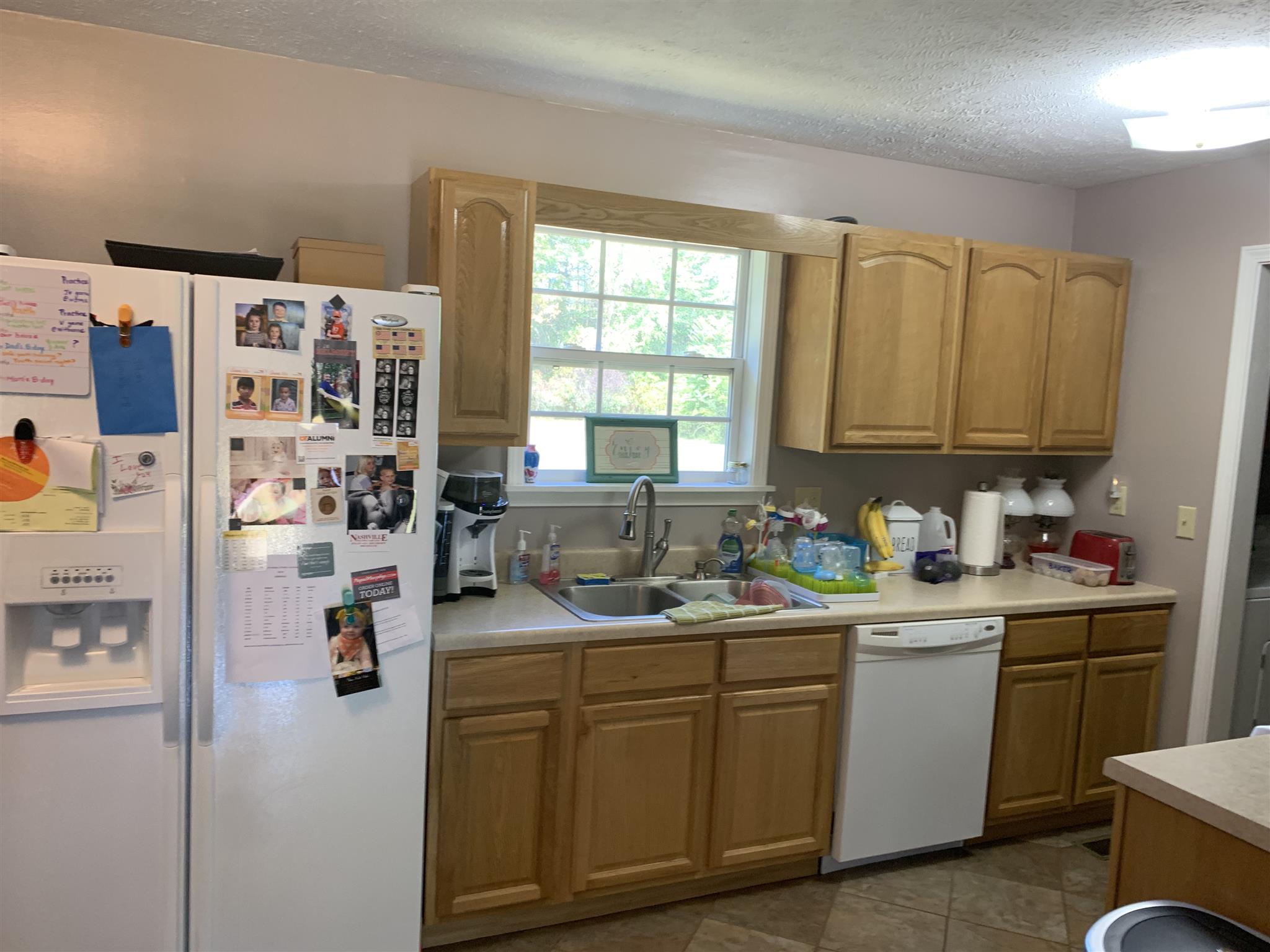 1225 Nelson Road Dickson, TN 37055 - Photo 6 of 18 a kitchen with stainless steel appliances granite countertop a sink dishwasher stove and refrigerator with wooden floor