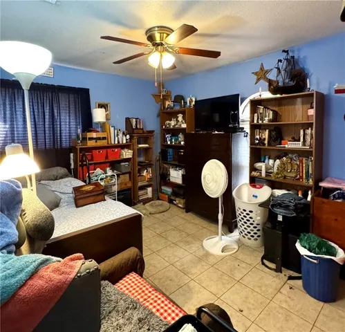 a living room with furniture a dining table and a chandelier