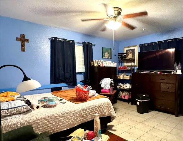 a bedroom with bed and a flat screen tv
