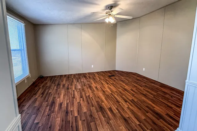 wooden floor in an empty room with a window