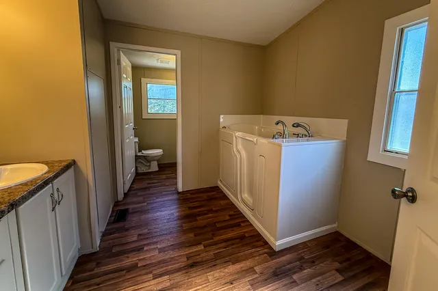 a view of a hallway with wooden floor
