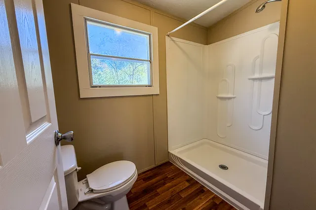 a bathroom with a granite countertop toilet a sink and bathtub