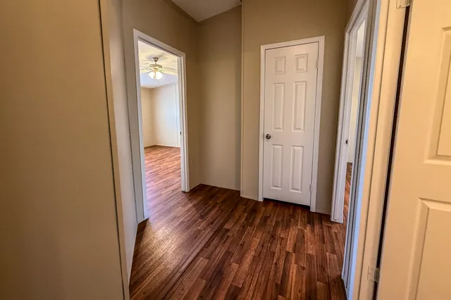 a view of a hallway with wooden floor