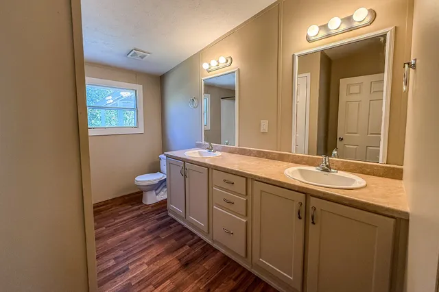 a bath room with sink and mirror