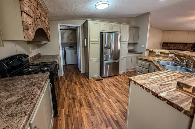 a kitchen with a refrigerator stove and sink