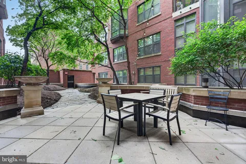 a view of a patio with table and chairs and potted plants