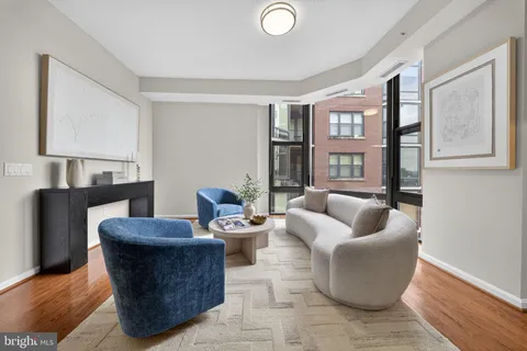a living room with furniture and a lamp