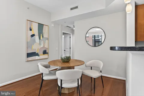 a dining room with furniture and wooden floor
