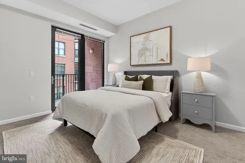 a bedroom with a bed and painting on the wall