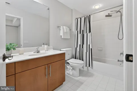 a bathroom with a sink toilet a mirror and shower