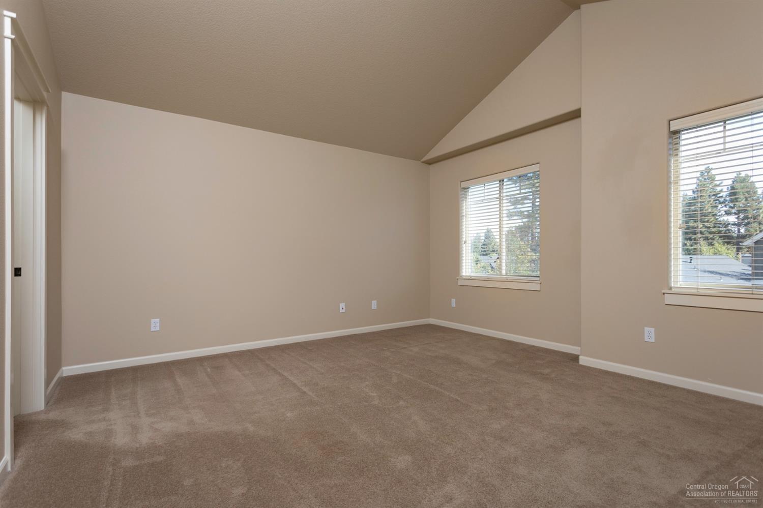 60303 Addie Triplett Loop Bend, OR 97702 - Photo 9 of 21 Large master bedroom with vaulted ceilin