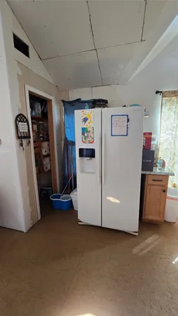 a view of a storage & utility room with closet window