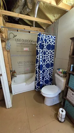 a bathroom with a toilet and a shower