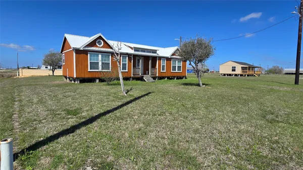 a front view of a house with a yard and porch