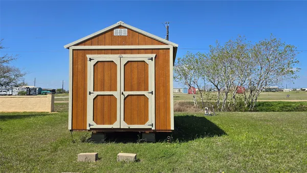 a view of a tiny house with garden