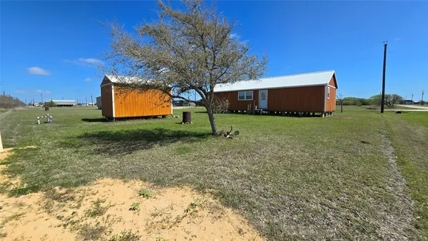 a view of a backyard with large trees