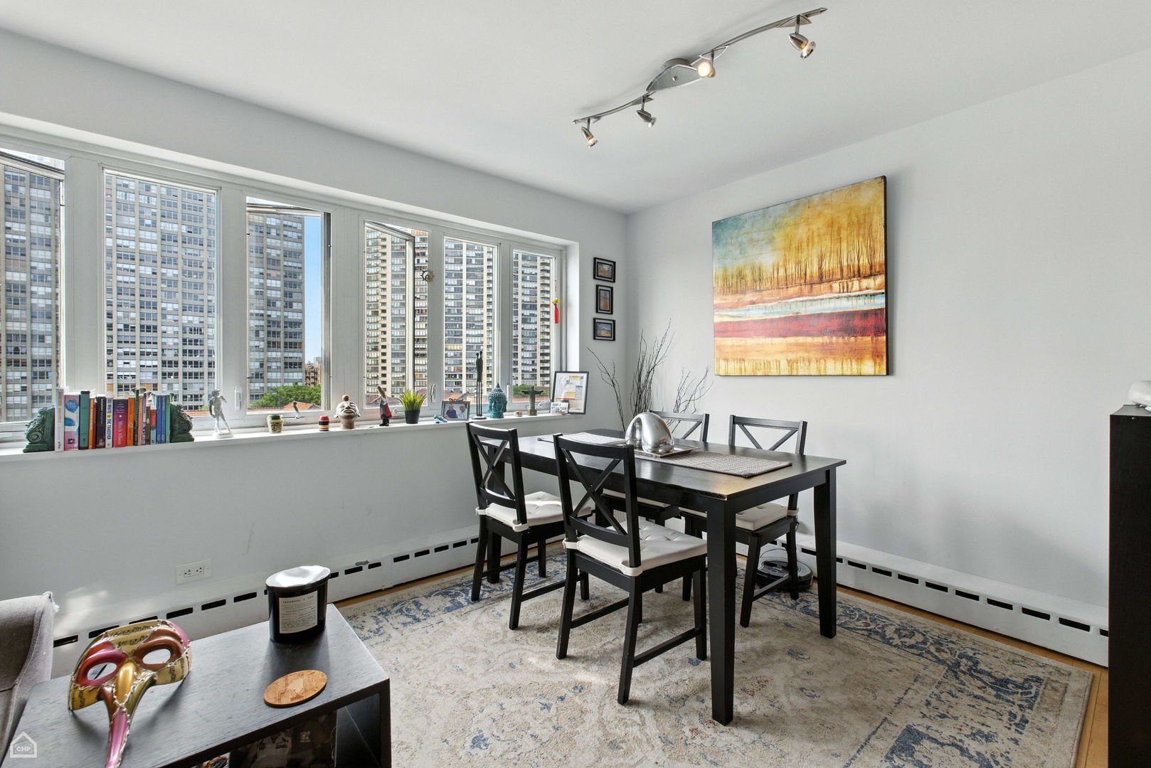 700 West Bittersweet Place, Unit 904 Chicago, IL 60613 - Photo 5 of 11 a view of a dining room with furniture and a window