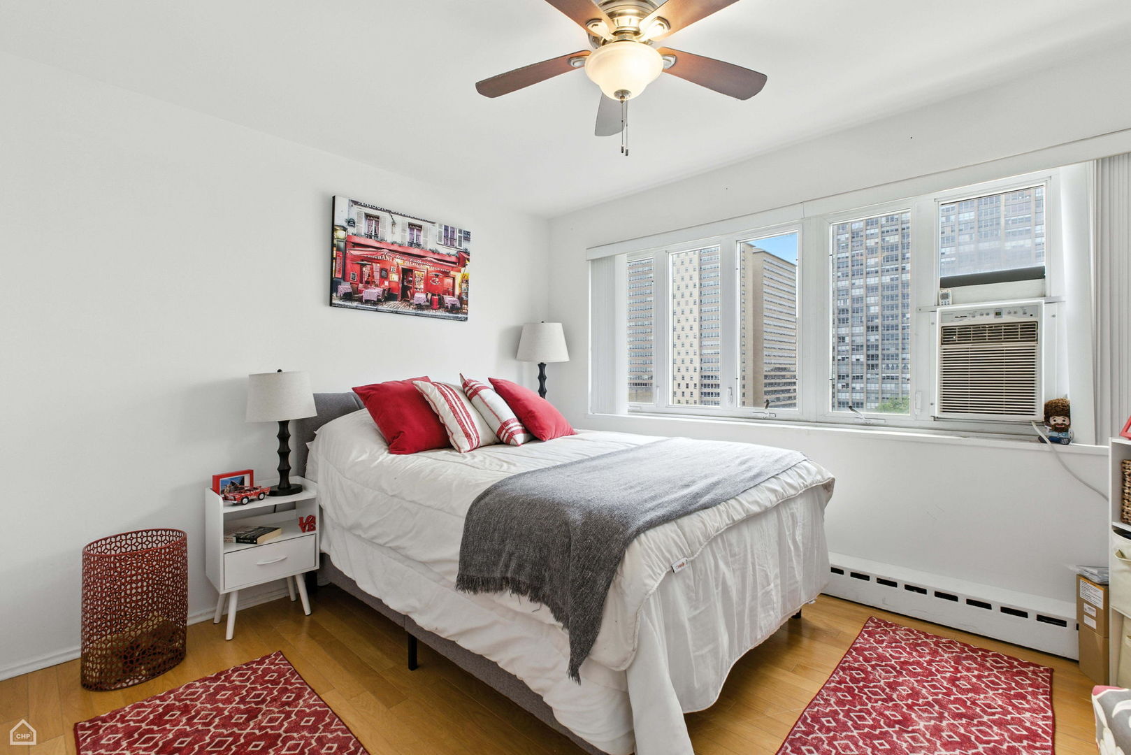 700 West Bittersweet Place, Unit 904 Chicago, IL 60613 - Photo 10 of 11 a bedroom with a bed and a window