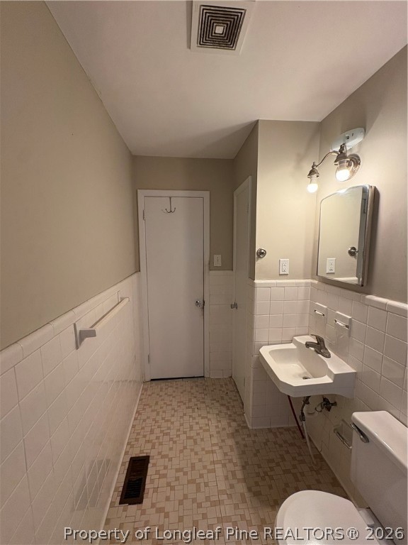 440 North Grogg Street Spring Lake, NC 28390 - Photo 16 of 23 a bathroom with a sink a toilet and a mirror