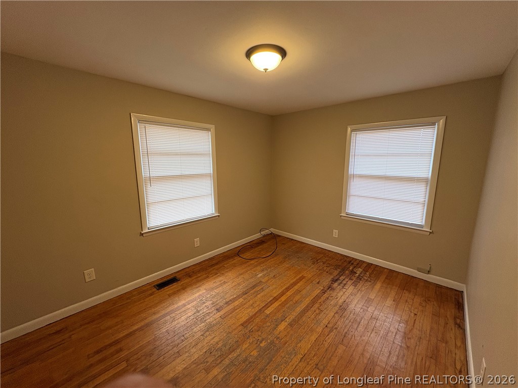 440 North Grogg Street Spring Lake, NC 28390 - Photo 18 of 23 a view of an empty room with wooden floor and a window