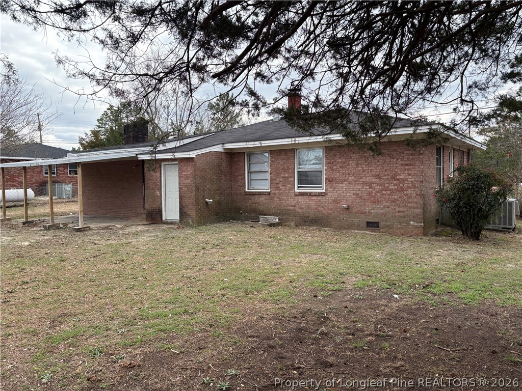 440 North Grogg Street Spring Lake, NC 28390 - Photo 22 of 23 a backyard of a house with plants and large tree