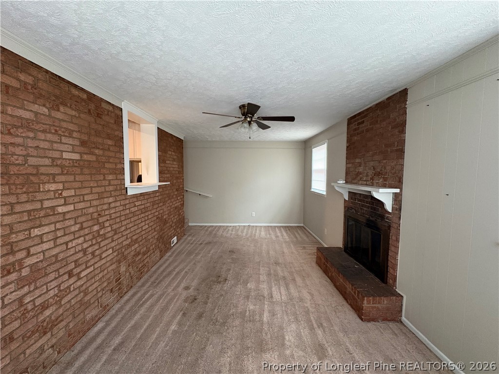 440 North Grogg Street Spring Lake, NC 28390 - Photo 4 of 23 a view of a livingroom with wooden floor and a ceiling fan