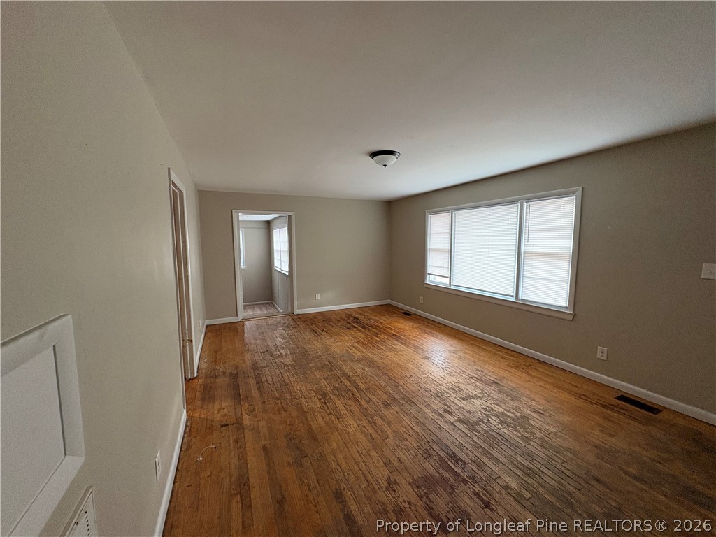 440 North Grogg Street Spring Lake, NC 28390 - Photo 6 of 23 wooden floor in an empty room with a window