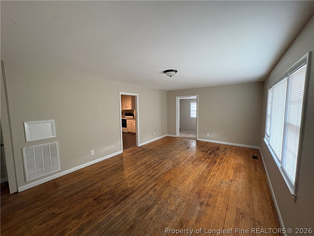 440 North Grogg Street Spring Lake, NC 28390 - Photo 7 of 23 wooden floor in an empty room with a window
