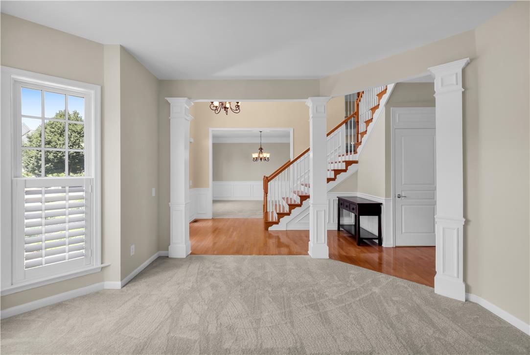 1709 Travers Road Breinigsville, PA 18031 - Photo 8 of 55 A spacious entry foyer seamlessly connects living areas, showcasing elegant millwork and a grand staircase.