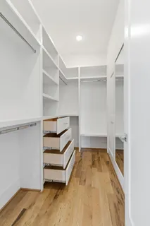 a bathroom with a double vanity sink a mirror and a shower