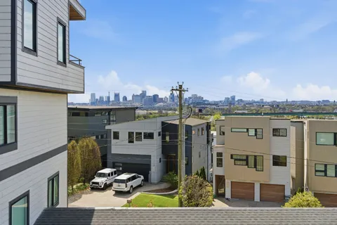 a view of a small space with wooden floor and a window