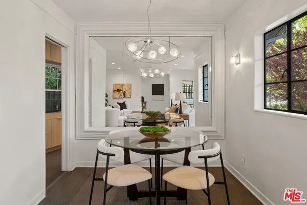 a view of a dining room with furniture and a chandelier