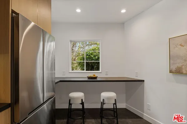 a view of a room that has a window and a wooden floor
