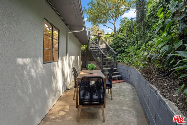 a view of a porch with furniture and floor to ceiling window